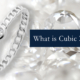 A piece of fine jewelry featuring a white CZ stone with the text “What is cubic zirconia?” next to the ring.